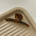 Close-up of tortoise shell pattern acetate shark hair claw with Babyvovo La France text - Caramel Amber