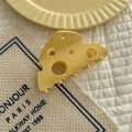 Detail of cheese-shaped hair claw with realistic holes and smooth cream finish - Large Cheese Hair Claw