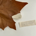 Detail of cream white acetate hair claw clip with France Handmade engraving and leaf decor - Teardrop Hair Clip