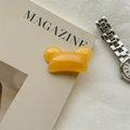 Detailed close-up of handmade yellow jelly bear hair clip with France engraving - Creamy Yellow