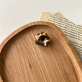 Detail of a handmade acetate flower hair clip with a stylish faux tortoiseshell texture - Brown Cow Print