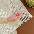 Macro shot of pink heart-shaped cutout on matte finish hair claw clip with bow design - Heart Duckbill Clip - Pink