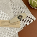 Macro shot of cream acetate hair claw with hollow heart detail and metallic spring - Heart Duckbill Clip - Beige