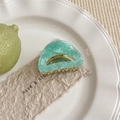 Vue détaillée de la pince à cheveux en acétate vert menthe marbré avec base dorée - Vert