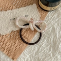 Detail of high-elasticity hair tie with marble-textured resin bow on decorative surface - Pink White Marble / Sakura Pink