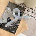 Close-up of 13cm oversized iridescent acetate hair claw clip with golden metal spring - Blue Gray Iridescent (13cm)