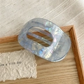 Macro detail of iridescent blue acetate hair claw clip with pearlescent texture and combs - Iridescent Blue Gray