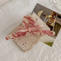Detail of pink marble acetate hair claw with handmade logo on beige travertine stone - Fine Packaging Style / Pink Marble