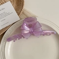 Close-up of a large purple acetate bow hair claw clip with golden handmade logo detail - Purple Stripe