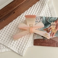 Detail of pink bow hair claw clip with handmade gold lettering and matte finish texture - Pink Striped