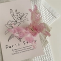 Detail of pink butterfly hair claw clip with glitter finish on floral prop card - Rose Red