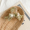 Detail of floral acetate hair claw with gold Handmade logo in a rustic wicker basket - Pink and Green