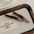 Detailed close-up of tortoise shell acetate hair clips with gold foil lettering - Blue Coffee (With Card)