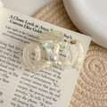 Iridescent wavy hair claw clip featuring large pearl and golden detail on fashion magazine - Pearl White