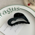 Close-up of heart-shaped chocolate acetate hair claw with golden Barrette La France text - Black