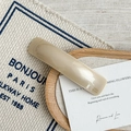 Close-up of a cream acetate hair clip with gold France Handmade lettering on wood - Cream White