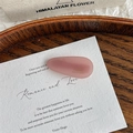 Detailed close-up of a pink matte acetate water drop hair clip with handmade gold lettering - Light Pink