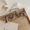 Detail view of the tortoiseshell leopard pattern wavy hair claw clip with silver spring - Leopard Print