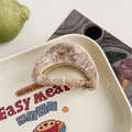 Detail of a marble-textured acetate hair claw clip with golden YD metal ornament - Floral Brown