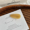 Detail of amber acetate teardrop hair clip showing France Handmade engraving - Light Yellow