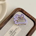 Detailed view of creative purple wave hair claw with gold metal spring on fabric base - Purple