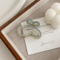 Detail of butterfly hair claw with pearlescent gradient green finish and gold spring - Green