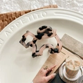 Detailed macro of a marble patterned acetate hair claw clip on an embossed white tray - Light Leopard
