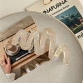 Detailed view of translucent wavy hair claw clip with pearlescent finish in warm beige - Iridescent Yellow (11cm)