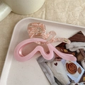 Detailed view of pink marble acetate wave hair claw with elegant gold logo on beige tray - Double Pink (Exquisite Packaging)