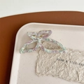 Macro view of butterfly acetate hair claw clip with purple marble pattern and gold metal frame - Green Purple