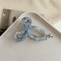 Detailed shot of light blue marble acetate hair claw clip on a ceramic tray - Light Blue