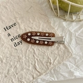 Close-up of brown acrylic hair clip featuring sparkling rhinestone flower patterns - Dark Coffee