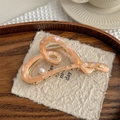 Detail of heart-shaped acetate hair claw clip with pearlescent marble texture and pearl - Pale Green