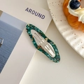 Detail view of oval acetate hair clip with marble texture on aesthetic lifestyle background - Starry Sky Green