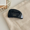Detail showing high-gloss black acetate hair claw clip with golden Barrette La France text - Black