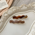 Detail of tortoise shell and amber wave hair clips with Barrette La France engraving - Striped Brown And Transparent Coffee