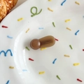 Macro detail of brown resin hair clip with France Handmade text on ceramic plate - Yellow Brown