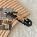 Detail of yellow cartoon cat hair clip on a black base with aesthetic props - Yellow Cat