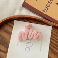 Detail view of pink marble wave hair claw clip on wooden plate and book backdrop - Pink Marble Pattern / Pink