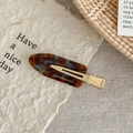 Macro detail of tortoiseshell acetate hair clip with Creation France gold engraving - Lake Blue Brown