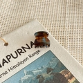 Close-up of tortoise shell pattern acetate hair claw clip on a vintage decorative card - Lake Blue Brown