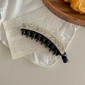 Detail view of Korean acetate banana hair clip with marble texture on vintage background - Beige Pattern