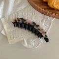 Close-up of tortoise shell banana hair clip with double-teeth on a vintage aesthetic background - Light Leopard