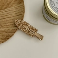 Elegant geometric brown acetate hair clip with golden metal base on a wooden tray - Argyle Brown