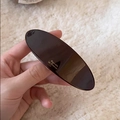 Minimalist dark brown acetate barrette with gold French lettering on soft plush background - Chocolate Brown