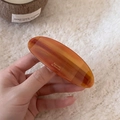 Amber acetate oval barrette with tortoiseshell texture and gold lettering for women - Brown