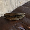 Macro shot of large acetate hair clip with vintage marble texture on dark wood background - Textured Grey
