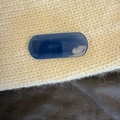 Close-up of a dark blue oval acetate hair clip with Creation France logo on knit fabric - Dark Blue