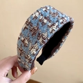 Close-up of French vintage tweed headband with blue and brown knitted wool texture - Coffee Blue