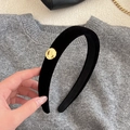 Close-up of black velvet headband with a decorative gold metal buckle on the side - Narrow Headband / Black
